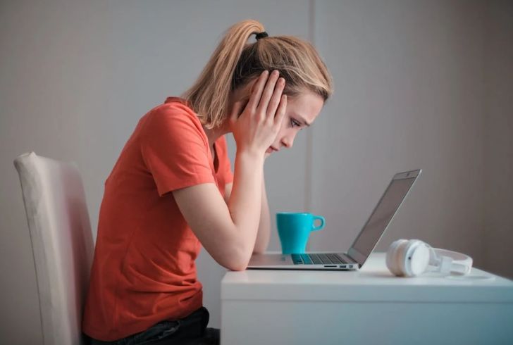 Professional woman managing menopause symptoms at work.